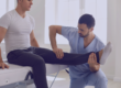 Man with physiotherapist holding knee