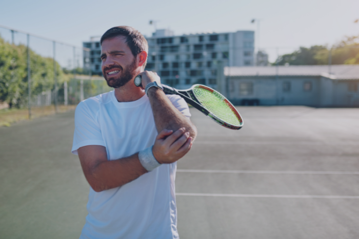 Tennis Elbow Diagnosis and Treatment Amateur tennis player holding elbow in pain