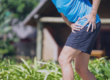 Man in shorts holding hip in pain