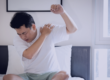 Man holding shoulder in pain