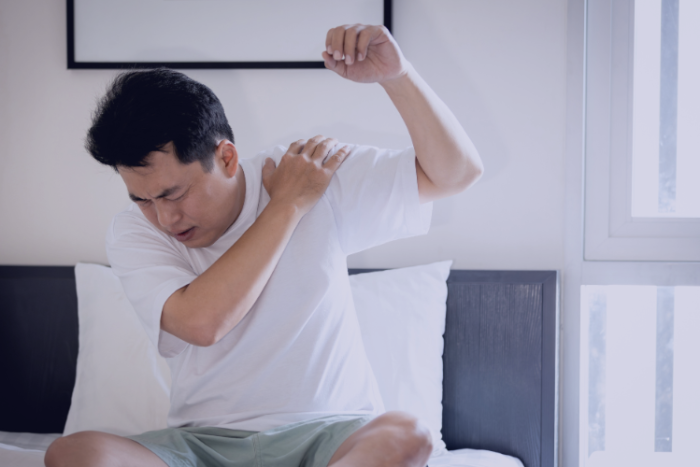 Painful Frozen Shoulder Treatments Man holding shoulder in pain